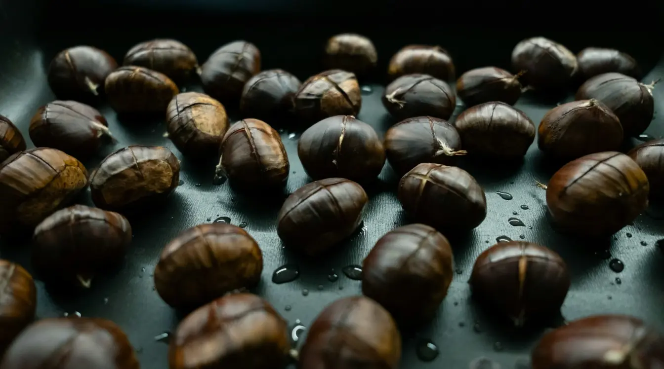 Roasted chestnuts on a dark tray