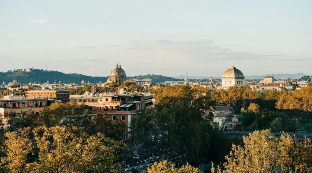 Rome skyline in autumn with historic domes and trees