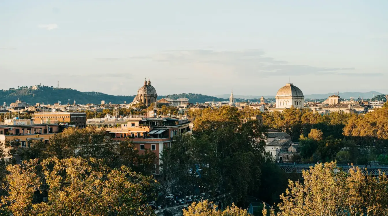 Rome skyline in autumn with historic domes and trees